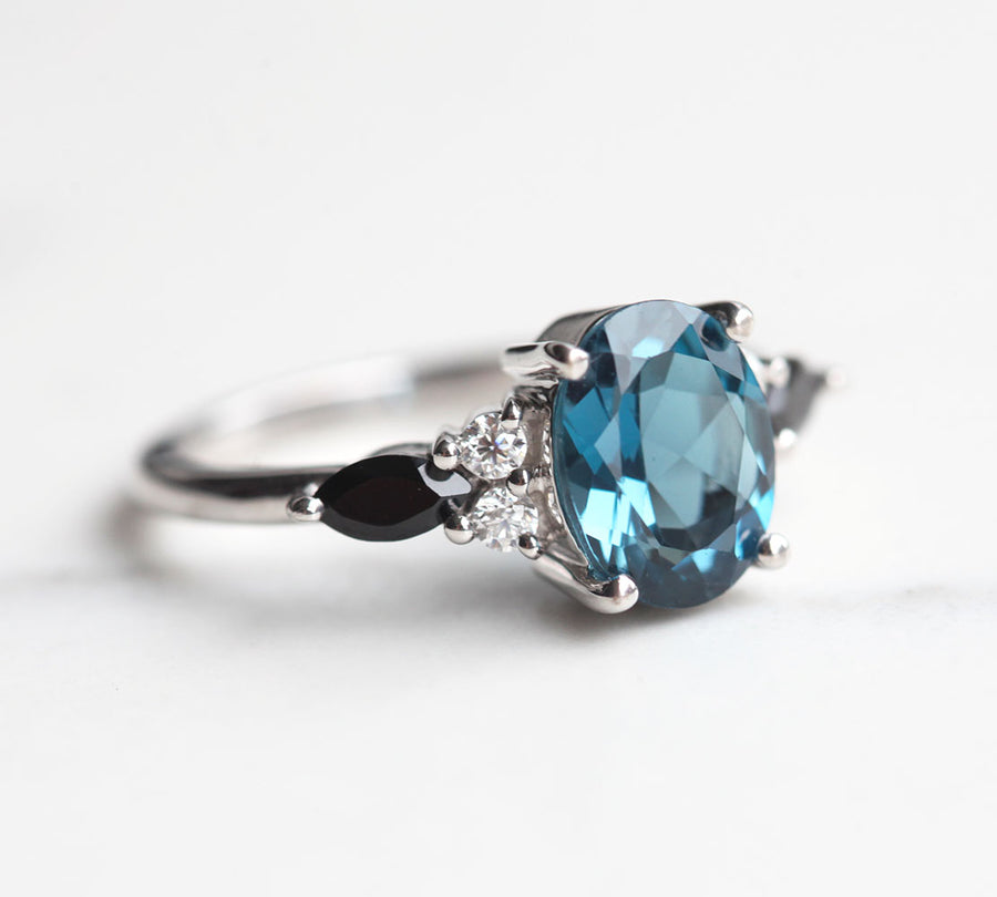 Lauryn Oval London Blue Topaz Ring with Moissanite and Black Spinel